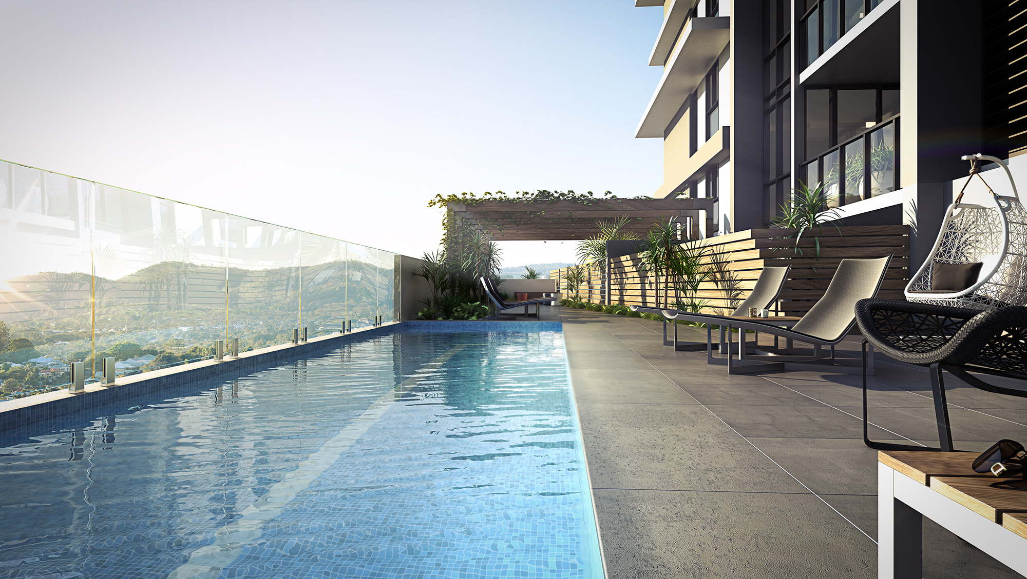 Rooftop pool area with breathtaking views of the Brisbane hinterlands, featuring lush planting, comfortable lounge chairs, and a pergola adorned with beautiful crawling vines.