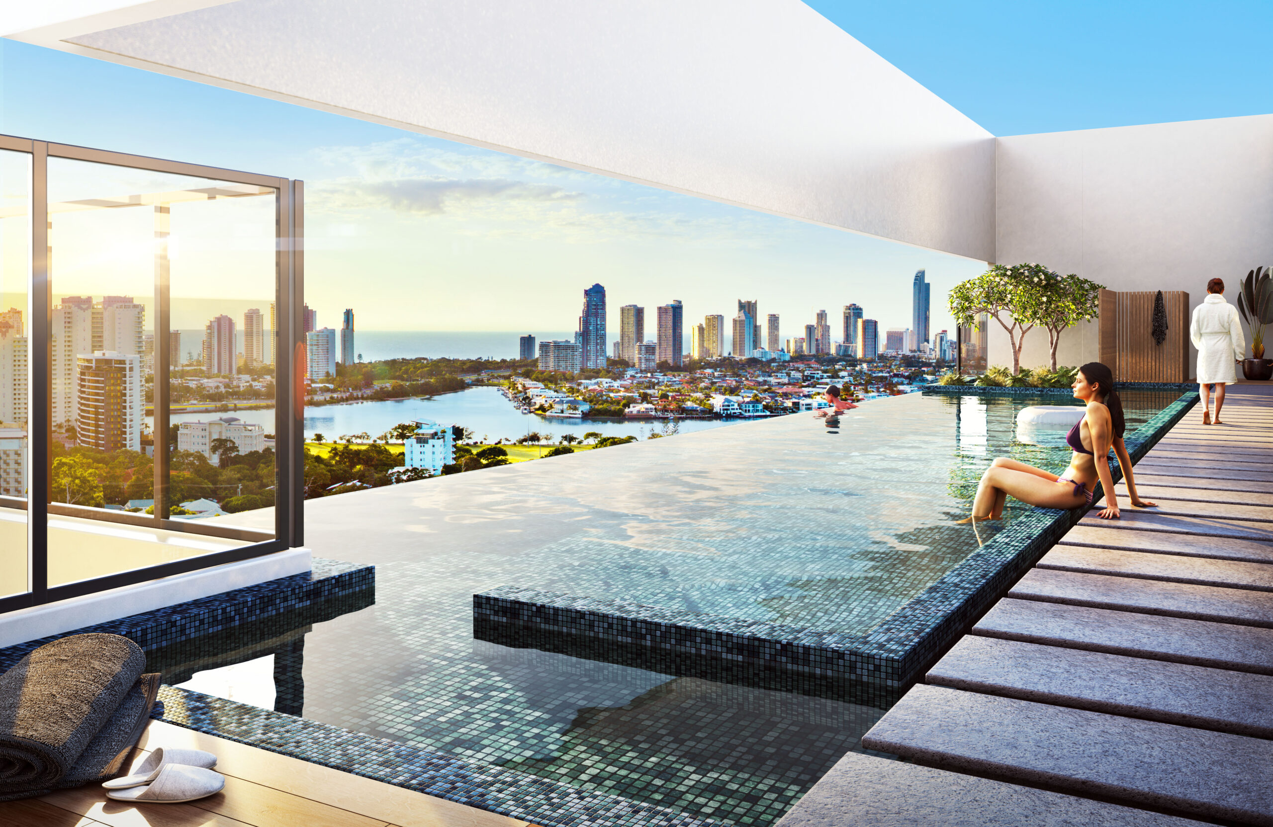 Rooftop pool area with stone stepping stone details alongside the pool and an infinity-style design offering breathtaking views of the Gold Coast skyline. The pool is framed by a white wall, leaving a gap at eye level for uninterrupted outward views.