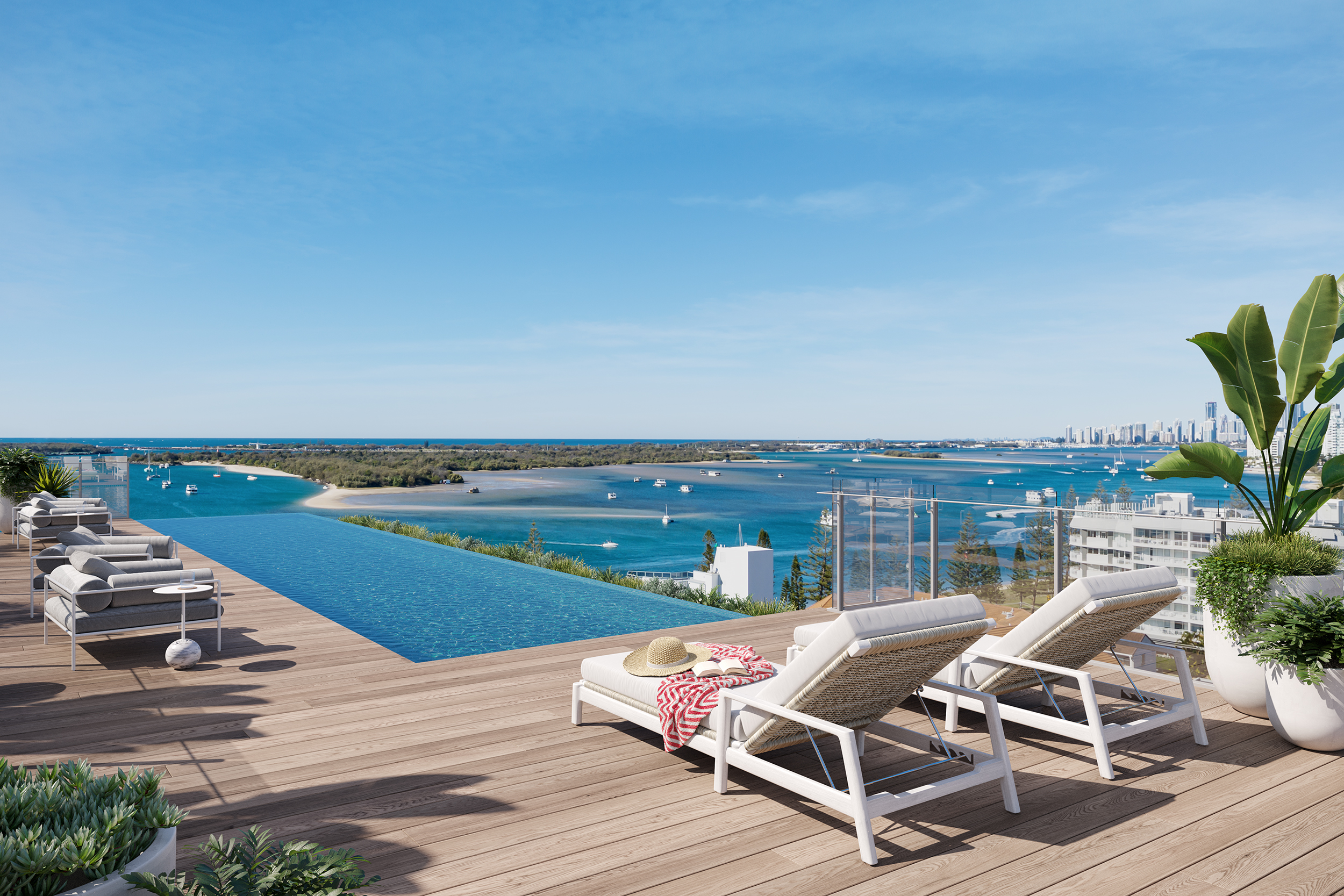 Breathtaking view from an infinity pool overlooking the ocean and the magnificent Gold Coast skyline. The poolside deck features a stylish timber finish and inviting lounge chairs.