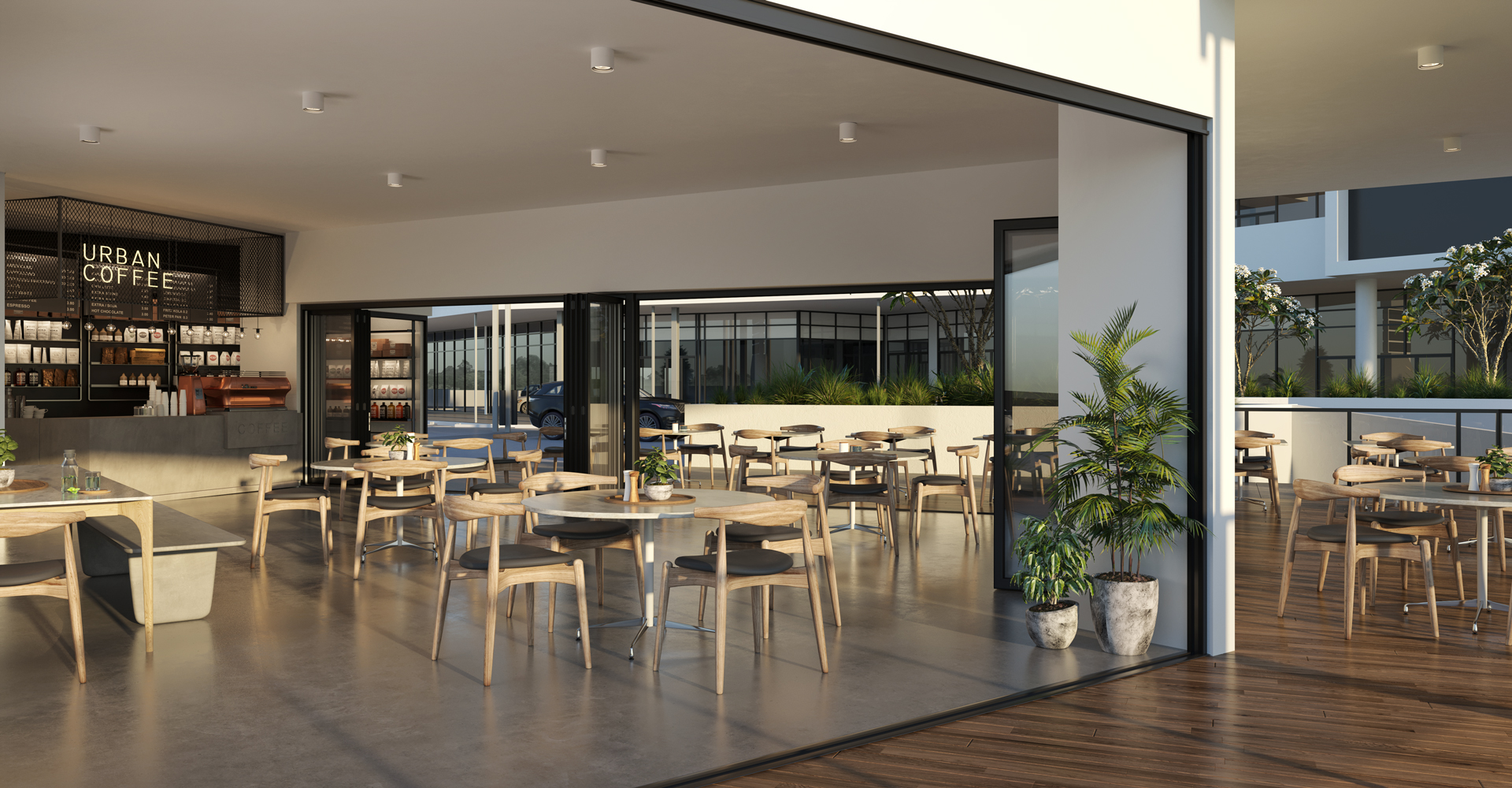 Looking to an open planned modern cafe that opens to the outside through large sliding doors